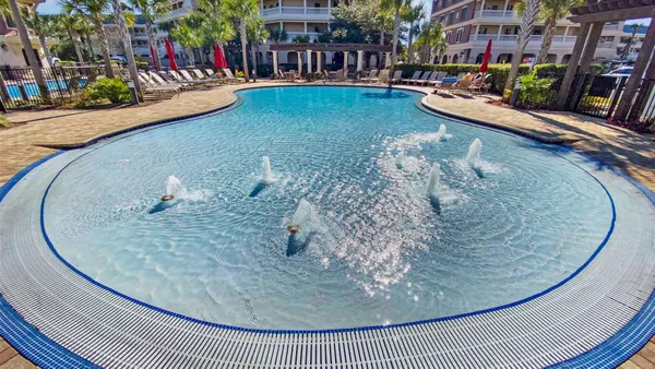 a view of a swimming pool with a outdoor seating