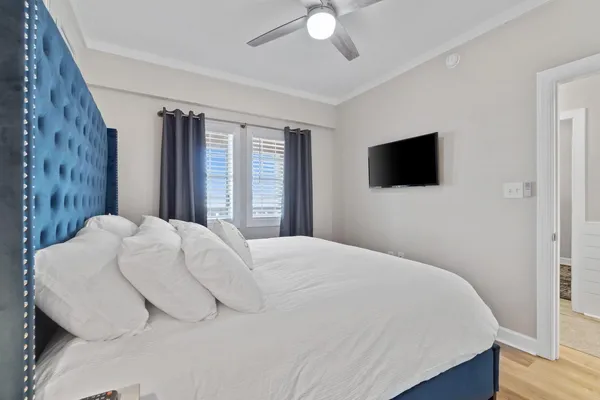 a bedroom with a large bed and a flat screen tv