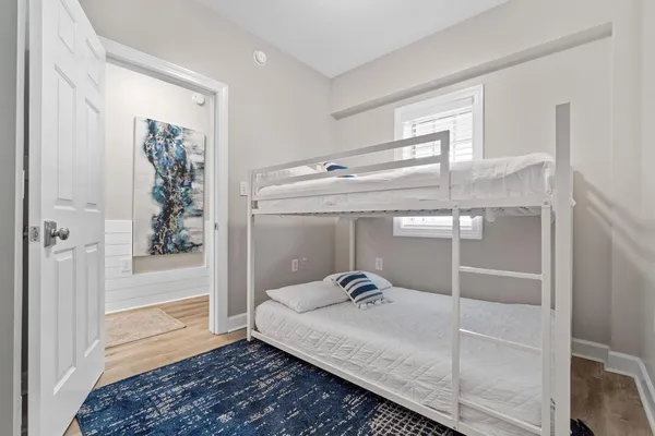 a bathroom with a granite countertop sink a mirror and shower