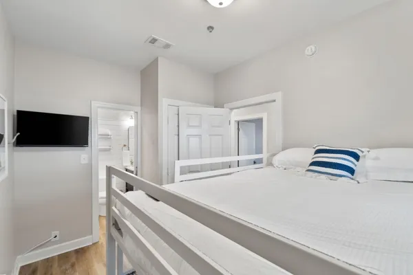 a room with a bed and a flat screen tv