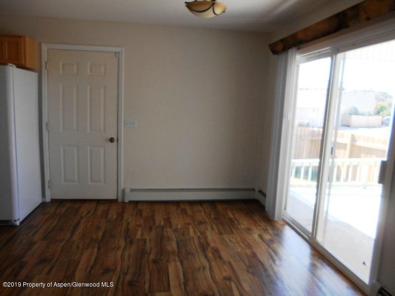 401 Evergreen Drive Rifle, CO 81650 - Photo 4 of 18 a view of an empty room with wooden floor and a window