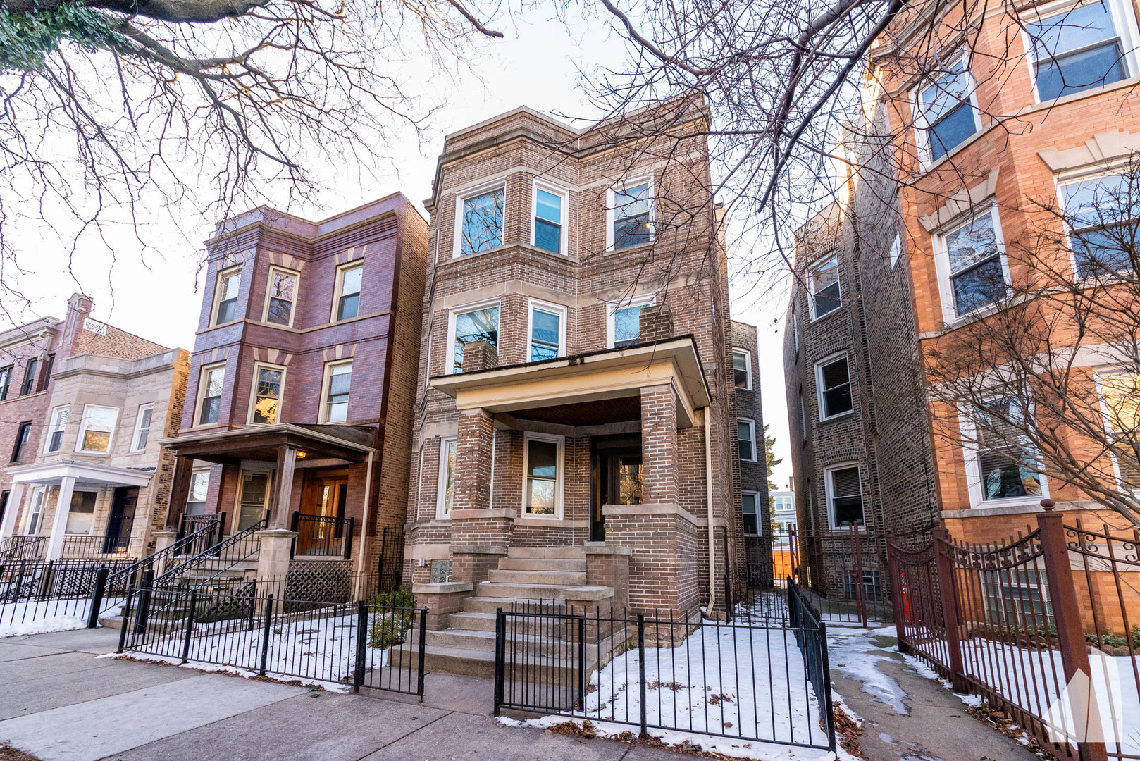 a view of a brick house with many windows