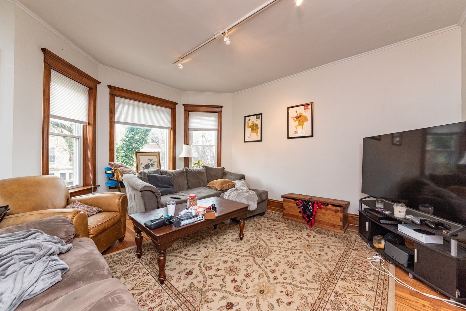 3716 North Racine Avenue, Unit 2 Chicago, IL 60613 - Photo 2 of 14 a living room with furniture and a flat screen tv