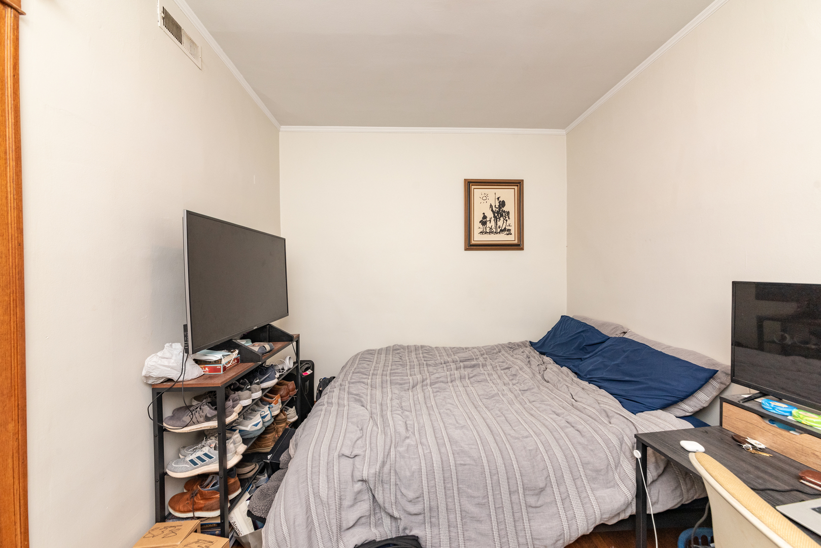 3716 North Racine Avenue, Unit 2 Chicago, IL 60613 - Photo 5 of 14 a bedroom with a bed and a flat screen tv