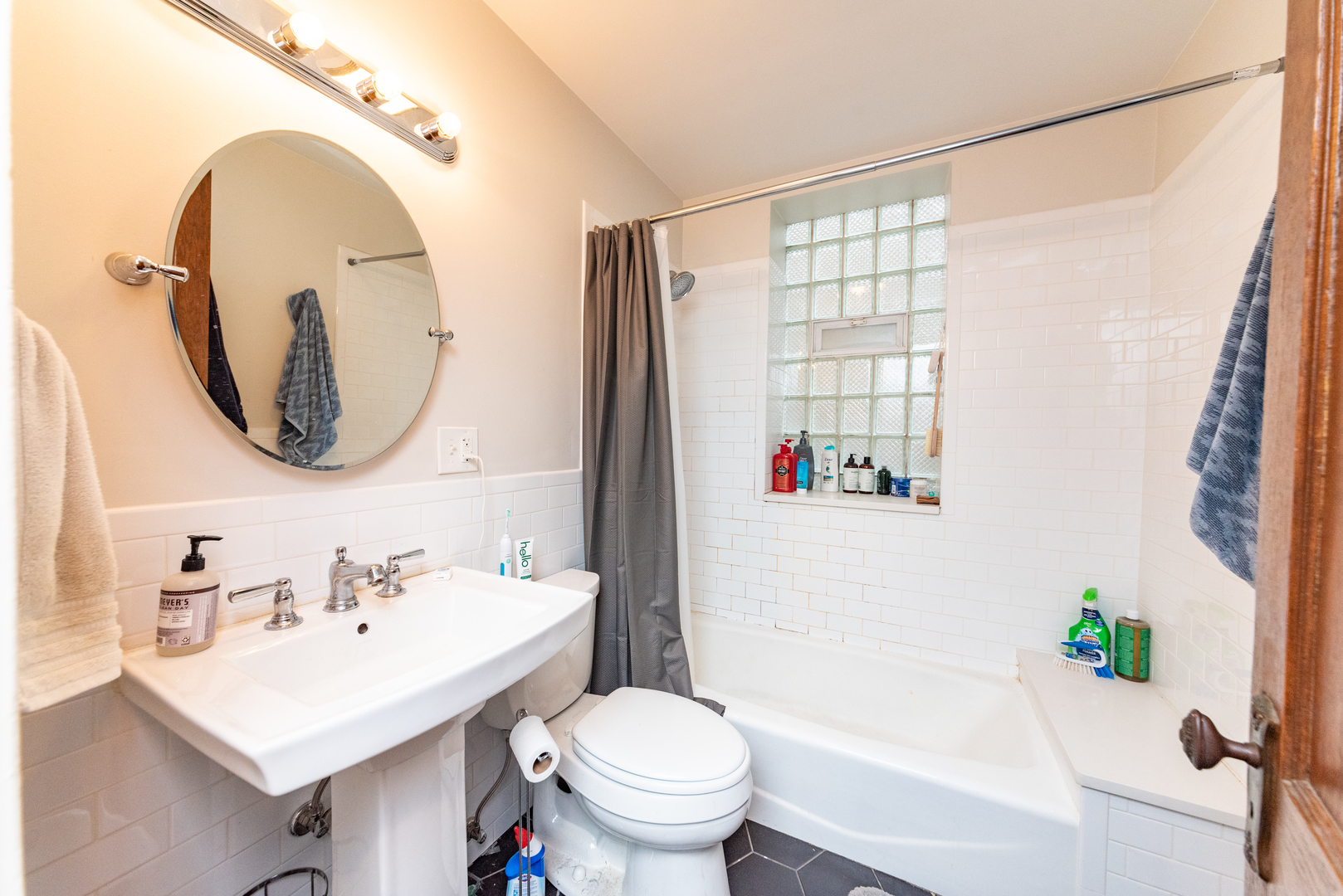 3716 North Racine Avenue, Unit 2 Chicago, IL 60613 - Photo 7 of 14 a bathroom with a sink toilet and a mirror