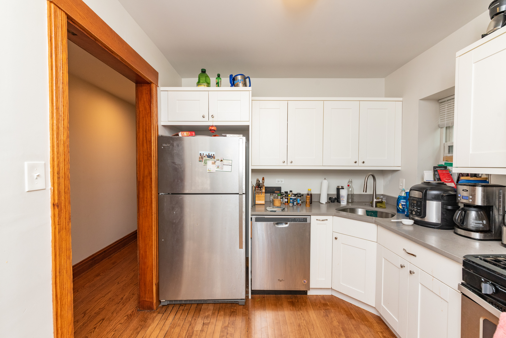 3716 North Racine Avenue, Unit 2 Chicago, IL 60613 - Photo 9 of 14 a kitchen with a refrigerator sink and cabinets