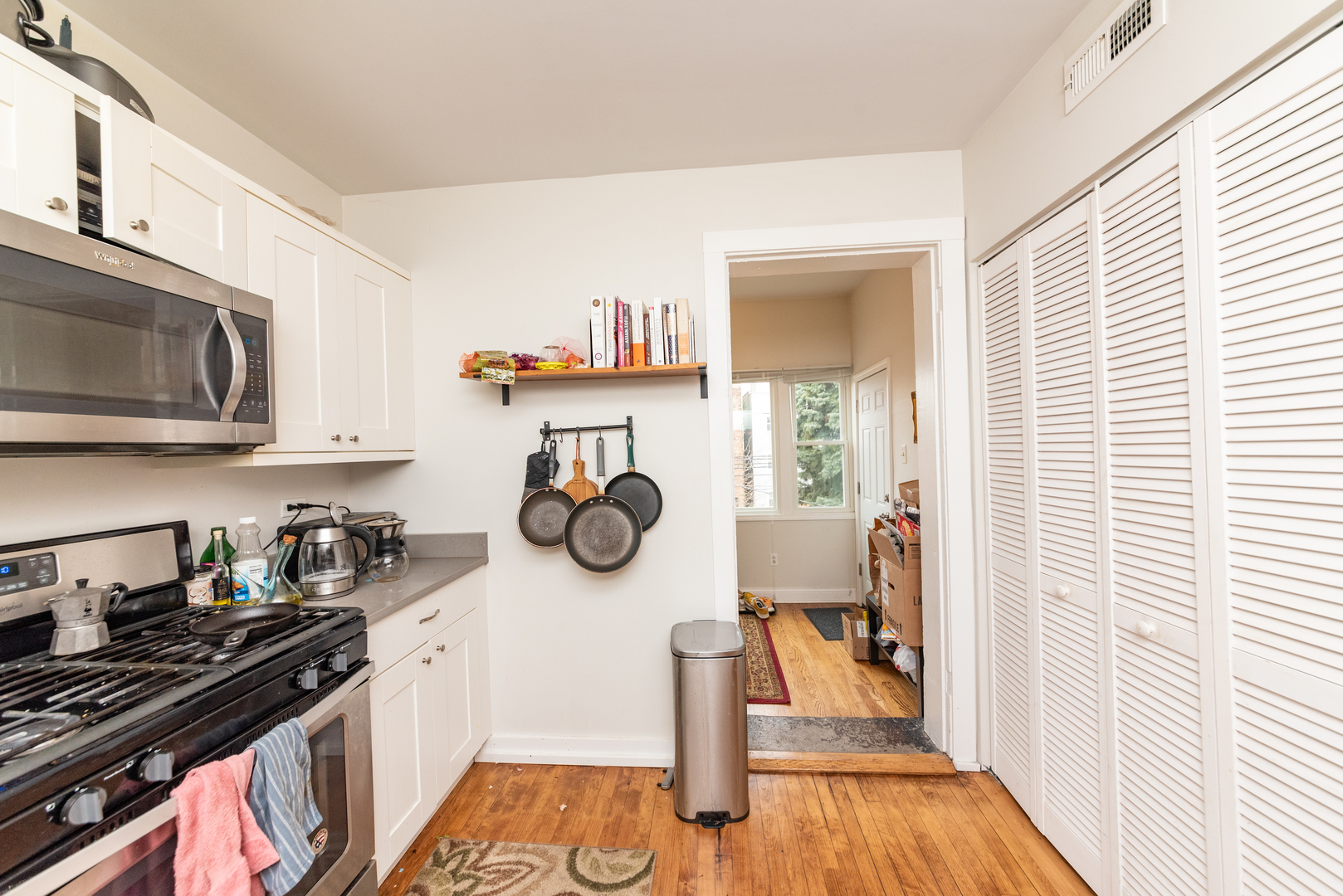 3716 North Racine Avenue, Unit 2 Chicago, IL 60613 - Photo 10 of 14 a kitchen with wooden cabinets and a stove top oven