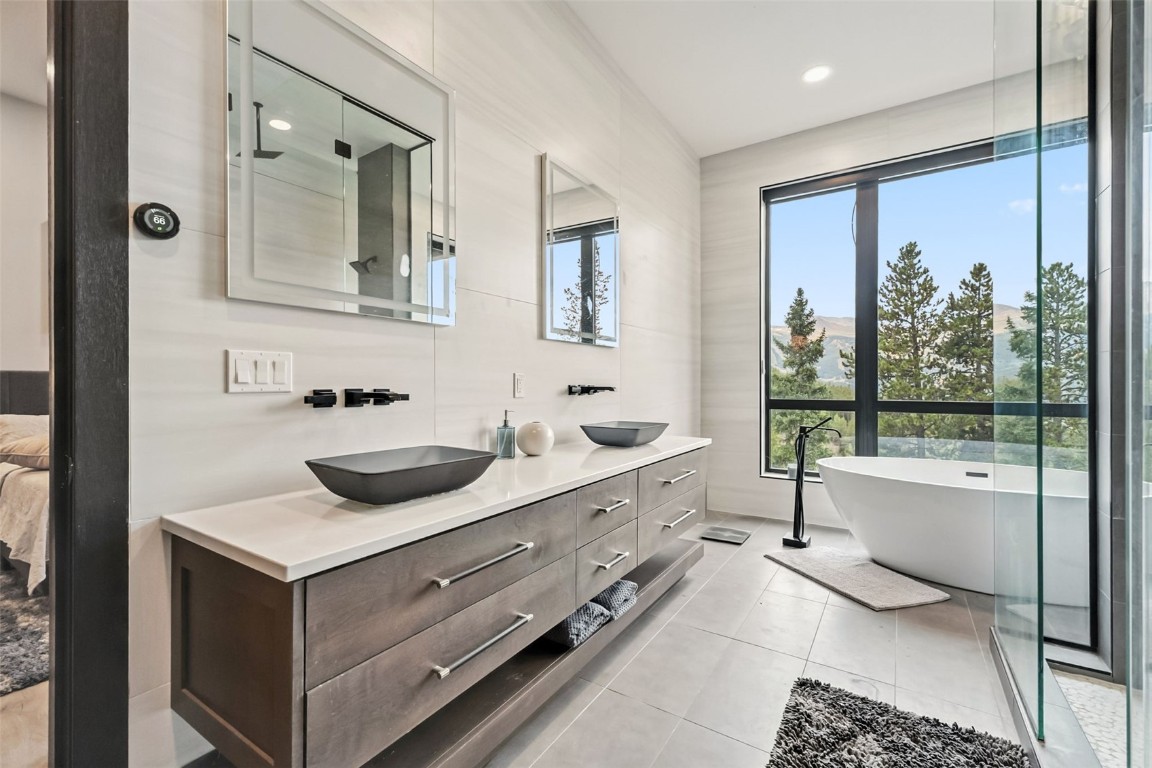 2520 Boreas Pass Road Breckenridge, CO 80424 - Photo 25 of 49 a bathroom with a tub sink and mirror