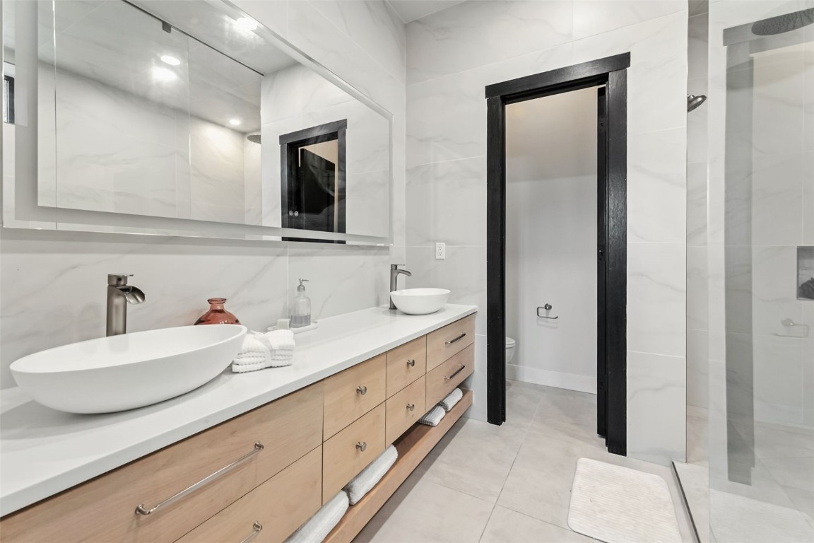 2520 Boreas Pass Road Breckenridge, CO 80424 - Photo 30 of 49 a spacious bathroom with a double vanity sink and a mirror