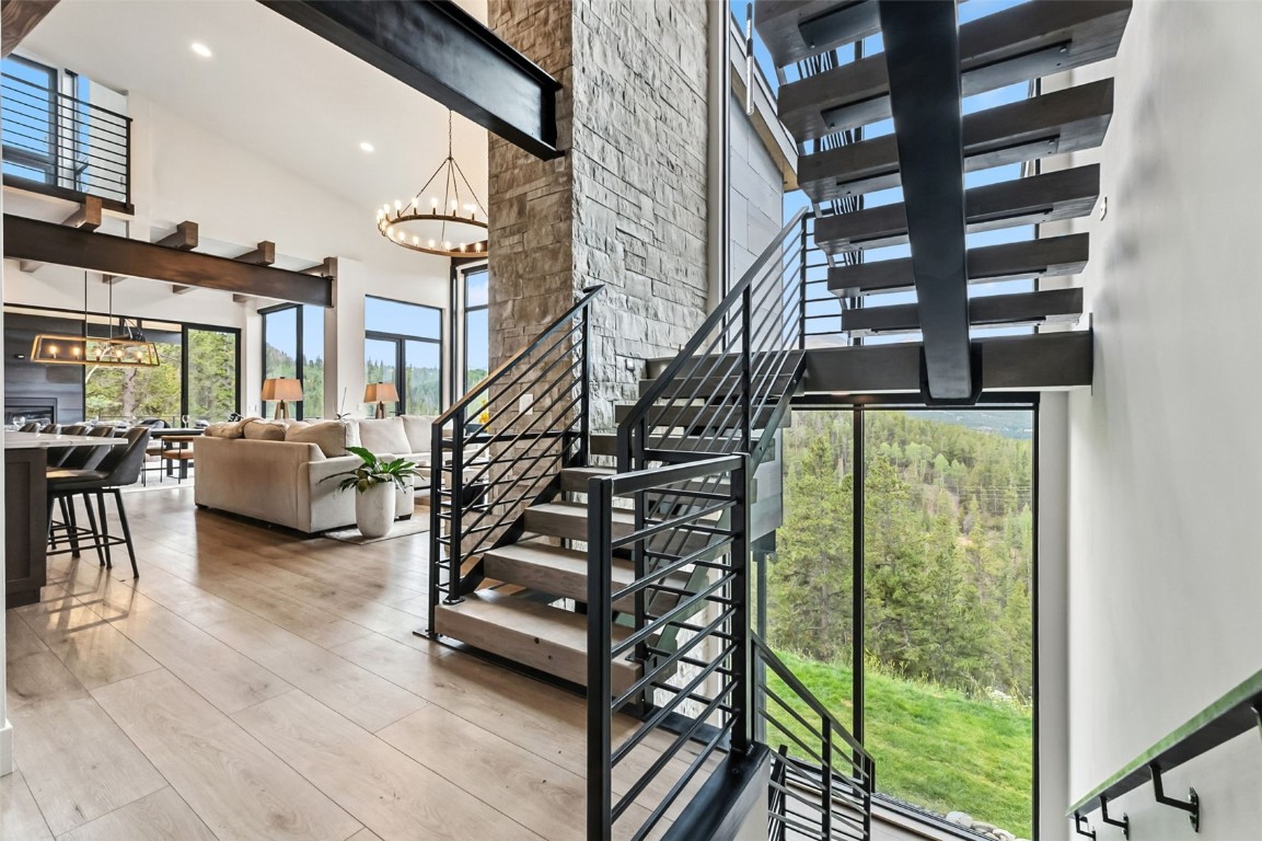 2520 Boreas Pass Road Breckenridge, CO 80424 - Photo 42 of 49 Staircase with a towering ceiling, recessed lighting, wood finished floors and tons of light!