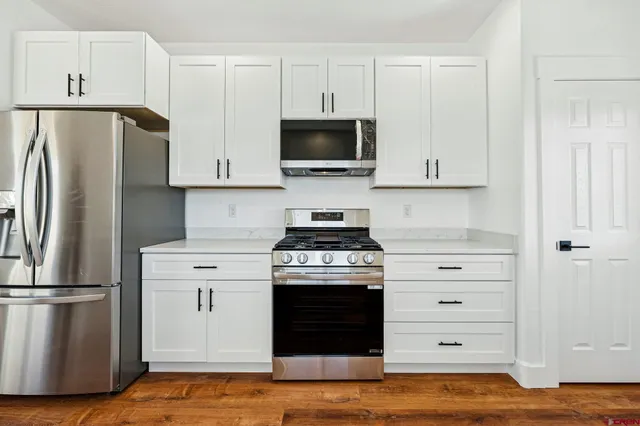 a kitchen with a stove and a refrigerator