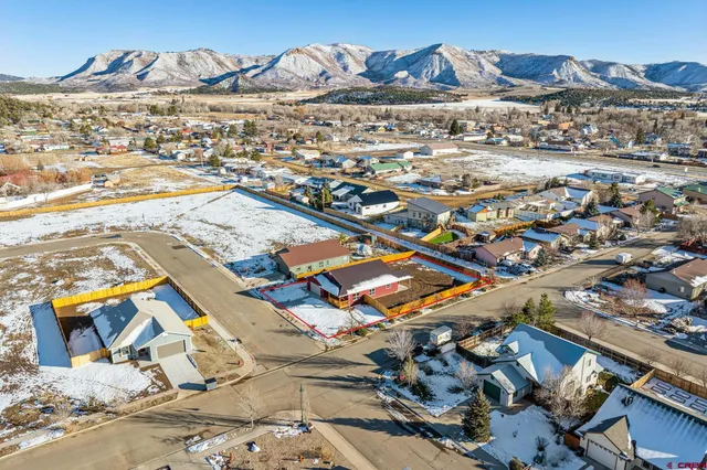 an aerial view of residential houses with outdoor space