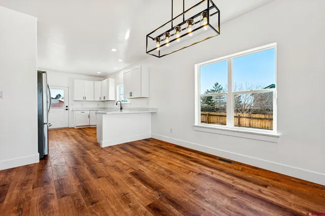 a kitchen with stainless steel appliances granite countertop a refrigerator and a stove top oven