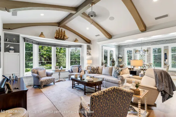 a living room with furniture and large windows