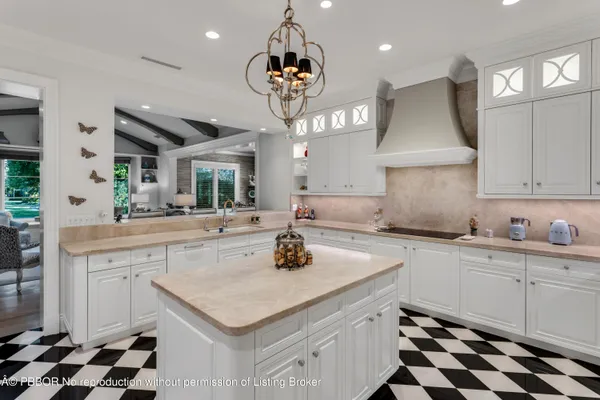 a kitchen with a sink a stove and cabinets