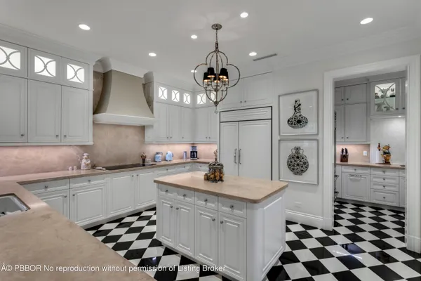 a kitchen with a sink a stove a refrigerator and cabinets