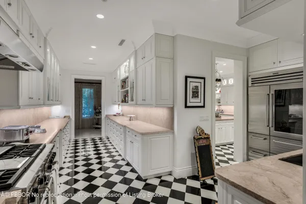 a kitchen with a sink a stove and a refrigerator