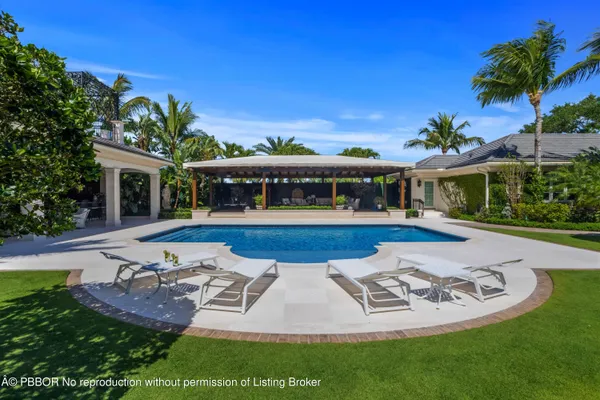 a view of a swimming pool with an outdoor space and seating area