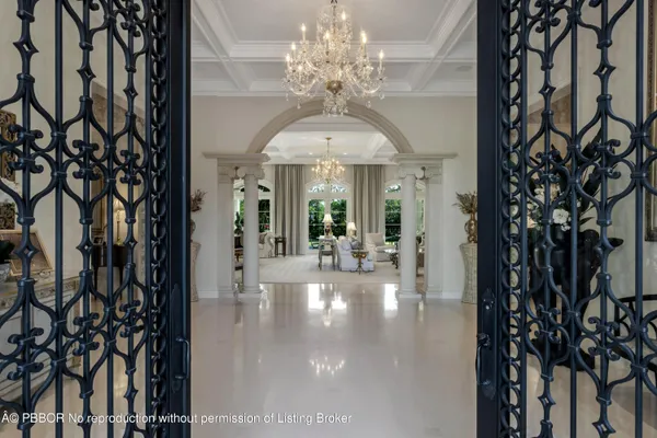 a view of a hallway with a dining table & chairs