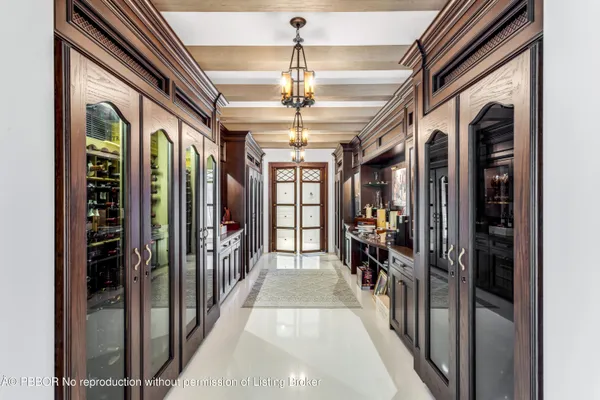 a hallway with a flower pot and a chandelier