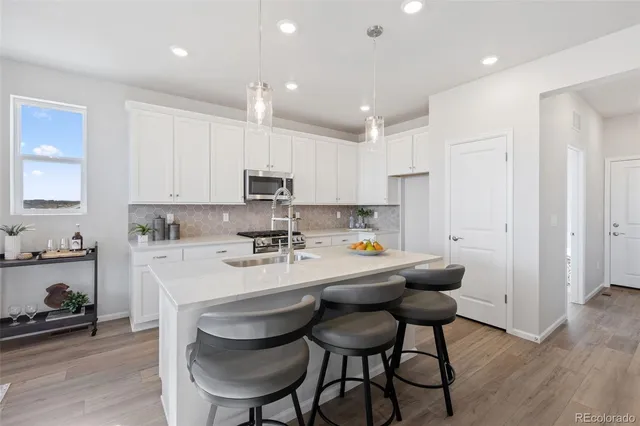 a kitchen with kitchen island wooden cabinets and stainless steel appliances