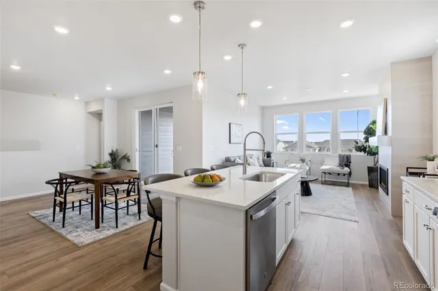 a kitchen with a table chairs stove and wooden floor