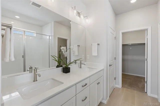 a bathroom with a double vanity sink mirror and double