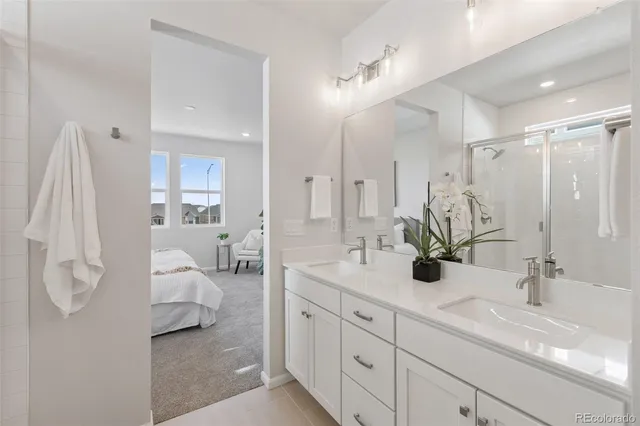 a en suite bathroom with double sink and a large mirror