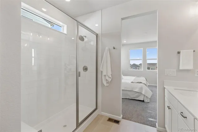 a bathroom with a shower and a sink