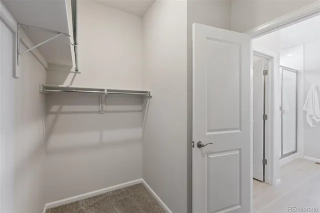 a view of walk in closet with empty racks