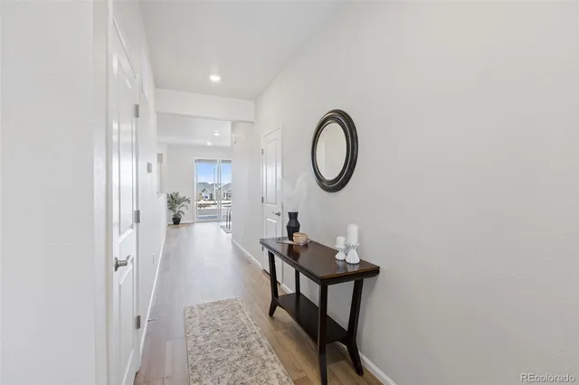 a living room with furniture a mirror and a window
