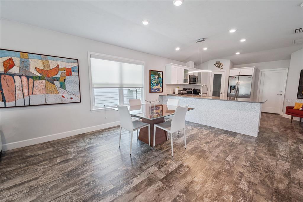 1790 Southwest 247th Street Newberry, FL 32669 - Photo 12 of 44 a view of a dining room with furniture a kitchen and chandelier