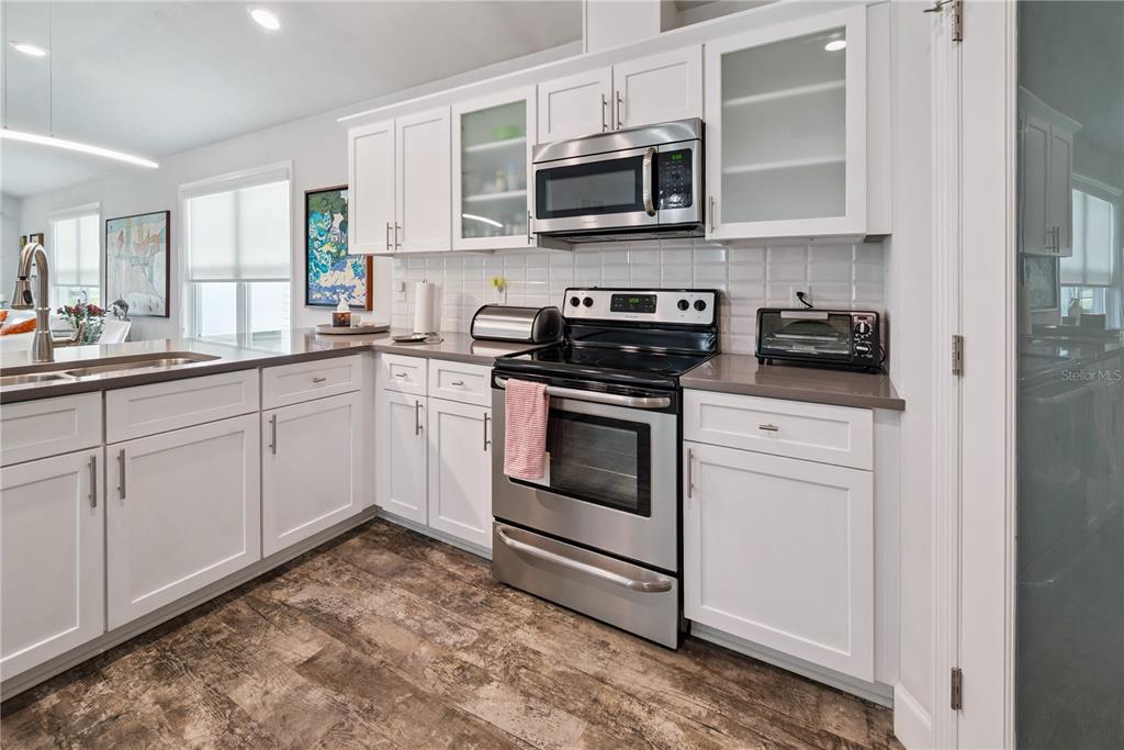 1790 Southwest 247th Street Newberry, FL 32669 - Photo 18 of 44 a kitchen with white cabinets stainless steel appliances and sink