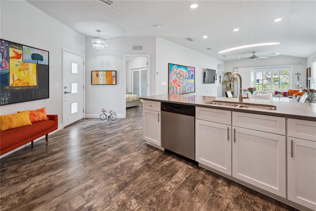 1790 Southwest 247th Street Newberry, FL 32669 - Photo 20 of 44 a kitchen with stainless steel appliances granite countertop a sink and dishwasher with wooden floor