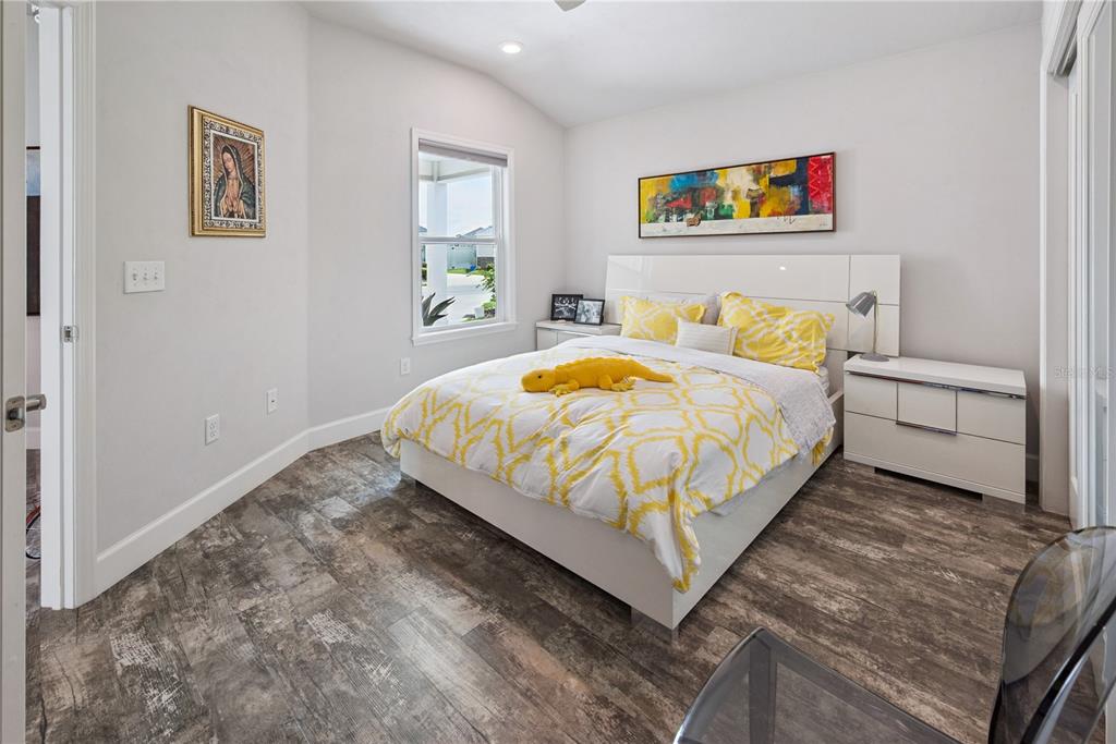 1790 Southwest 247th Street Newberry, FL 32669 - Photo 22 of 44 a bedroom with a bed and painting on the wall