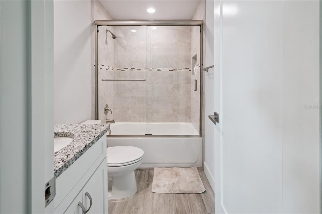 1790 Southwest 247th Street Newberry, FL 32669 - Photo 24 of 44 a bathroom with a granite countertop toilet a sink and shower