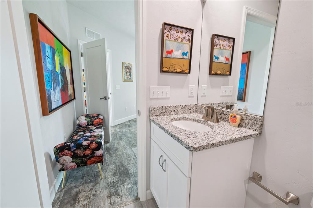 1790 Southwest 247th Street Newberry, FL 32669 - Photo 26 of 44 a bathroom with a granite countertop sink and a mirror
