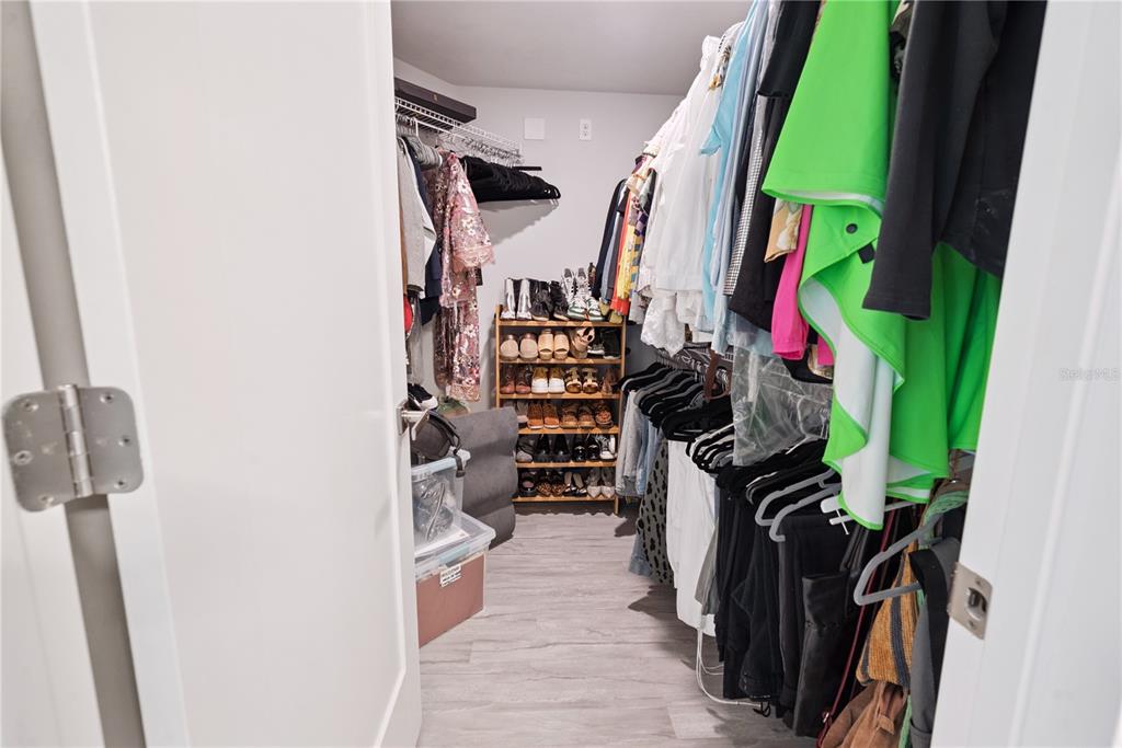 1790 Southwest 247th Street Newberry, FL 32669 - Photo 29 of 44 a view of walk in closet with clothes and shoes