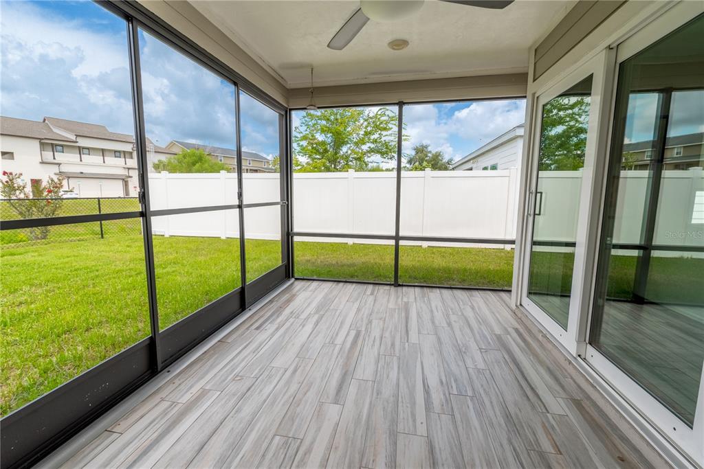 1790 Southwest 247th Street Newberry, FL 32669 - Photo 34 of 44 an empty room with floor to ceiling windows and an outdoor view