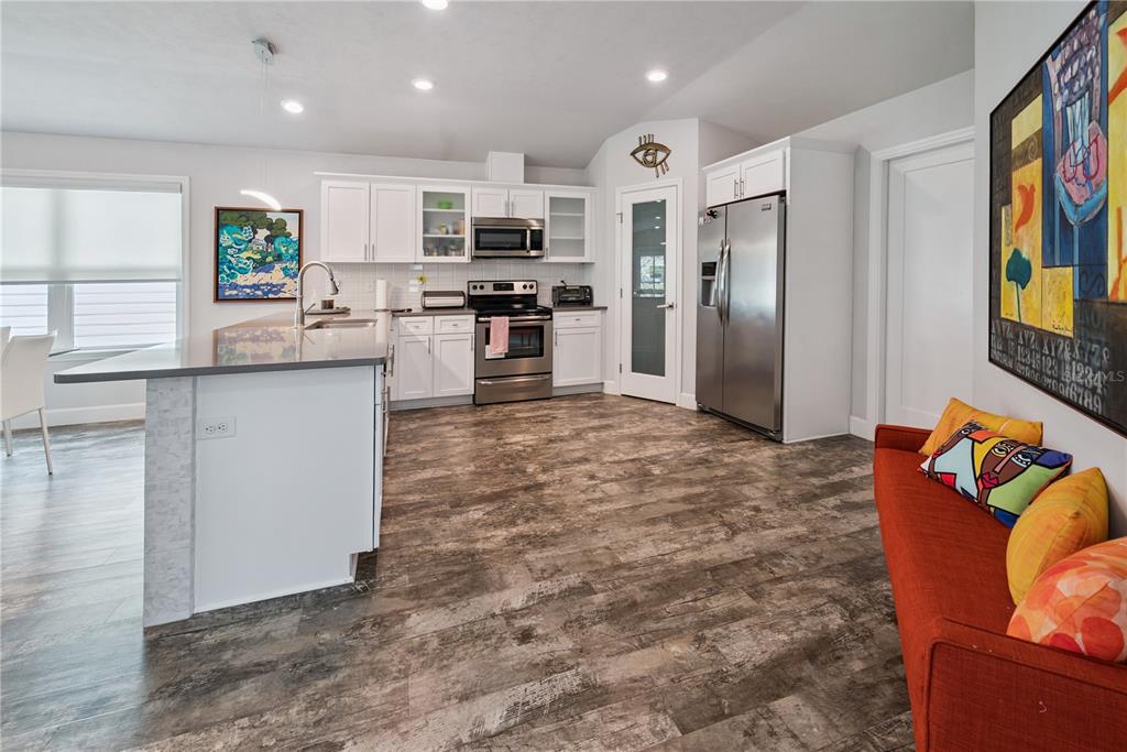 1790 Southwest 247th Street Newberry, FL 32669 - Photo 10 of 44 a kitchen with stainless steel appliances kitchen island granite countertop a refrigerator and a stove top oven