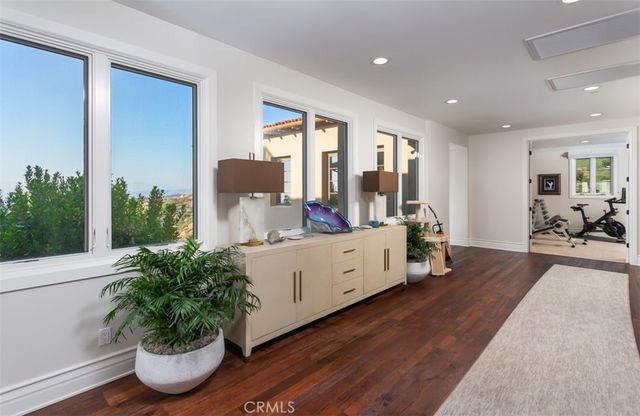 a living room with pool table and a large window