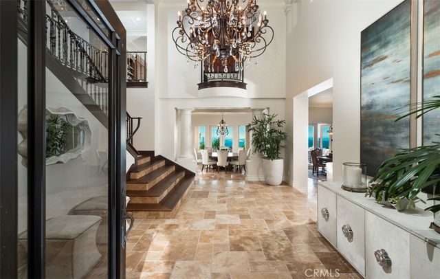 a living room with furniture a fireplace and potted plants with wooden floor