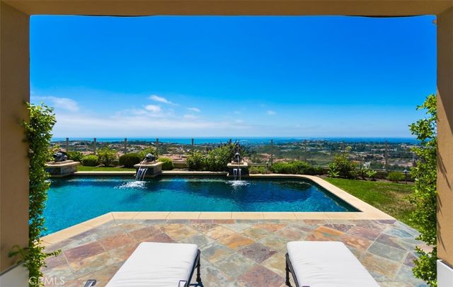 a view of a house with swimming pool and sitting area