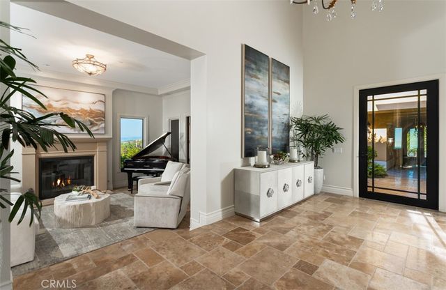 a living room with furniture a flat screen tv and a floor to ceiling window