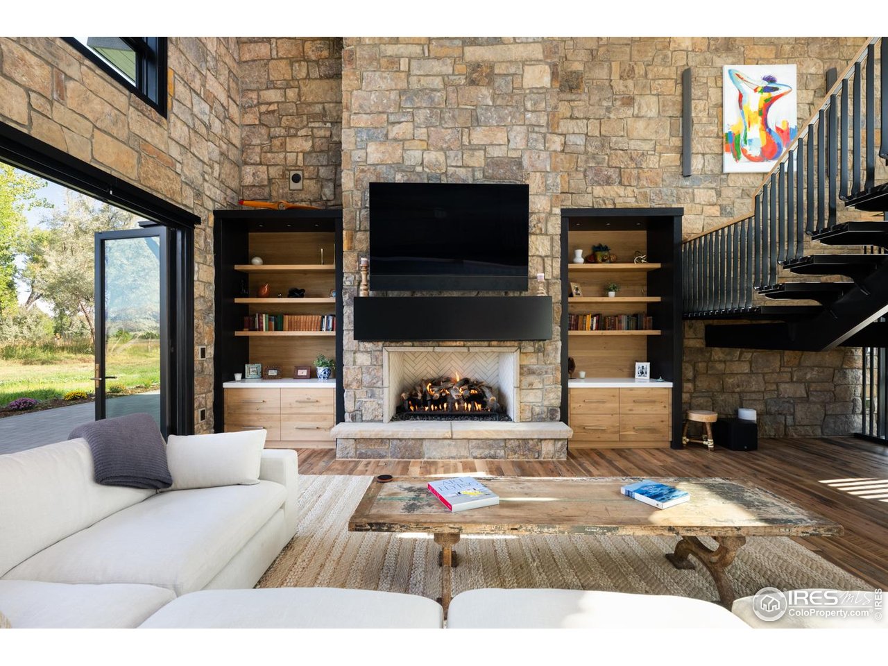 12357 North 75th Street Longmont, CO 80503 - Photo 11 of 49 a living room with fireplace furniture and a flat screen tv
