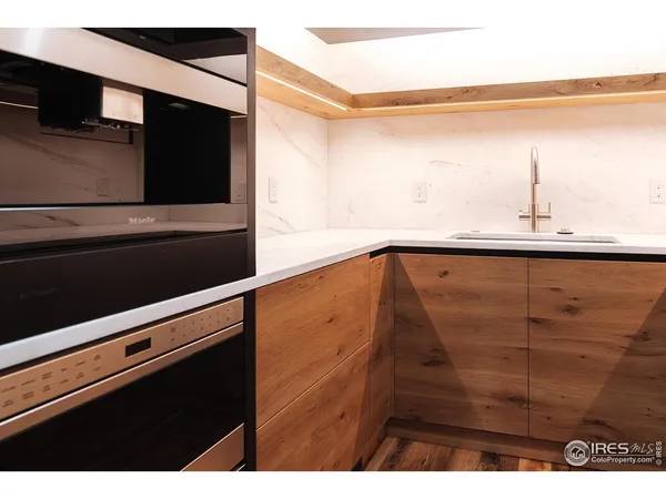 a kitchen with a sink and a refrigerator
