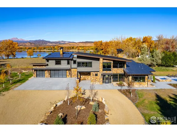 a view of a house with pool and a yard