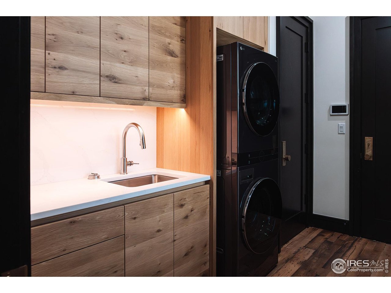 12357 North 75th Street Longmont, CO 80503 - Photo 21 of 49 a kitchen with a sink and a refrigerator