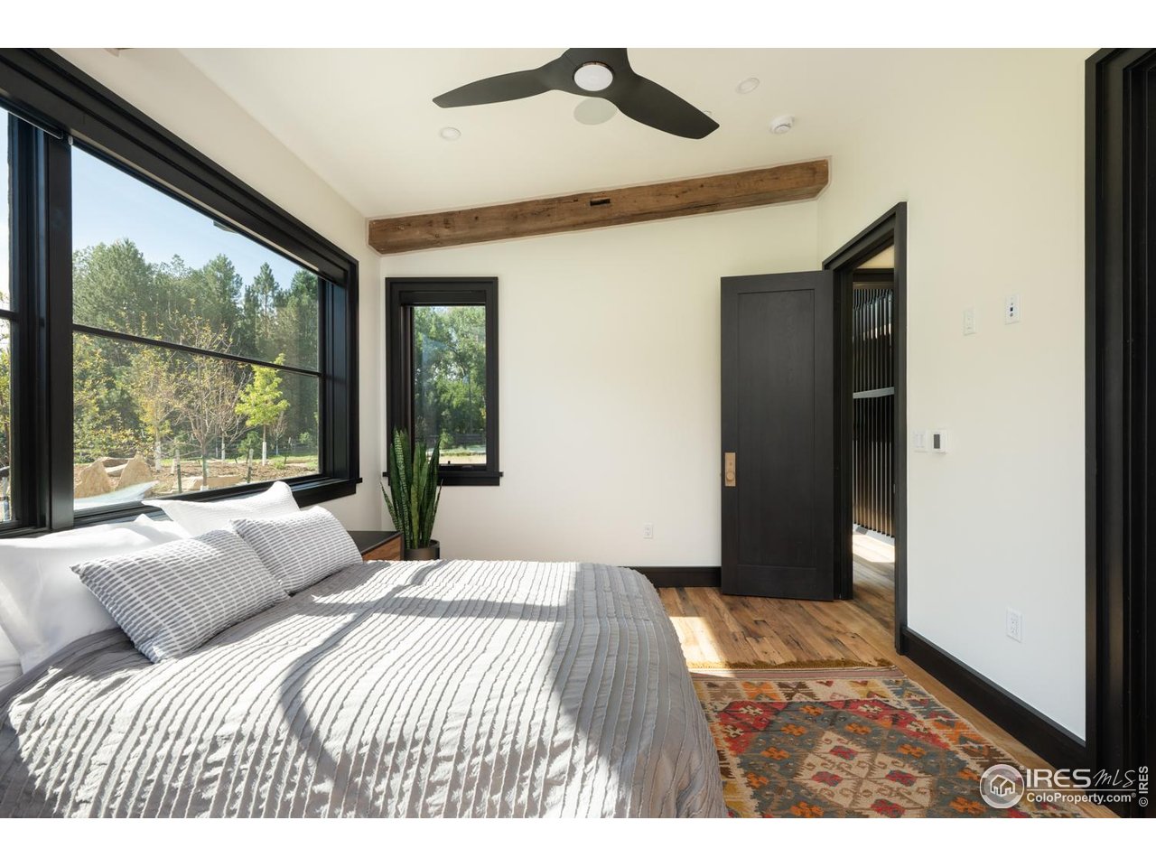 12357 North 75th Street Longmont, CO 80503 - Photo 37 of 49 a bedroom with a bed and a large window