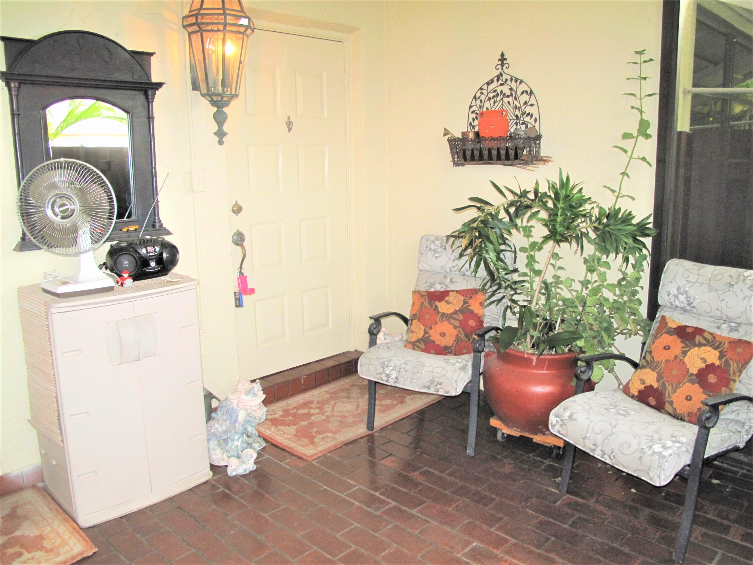 5031 Nesting Way, Unit D Delray Beach, FL 33484 - Photo 4 of 35 Front enclosed patio